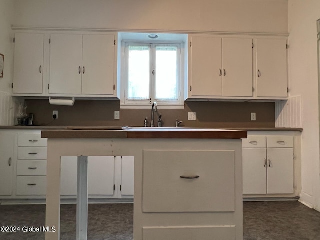 601/603 Baldwin Rd, Ticonderoga, NY 12883 - kitchen featuring white cabinets, a sink, and dark countertops