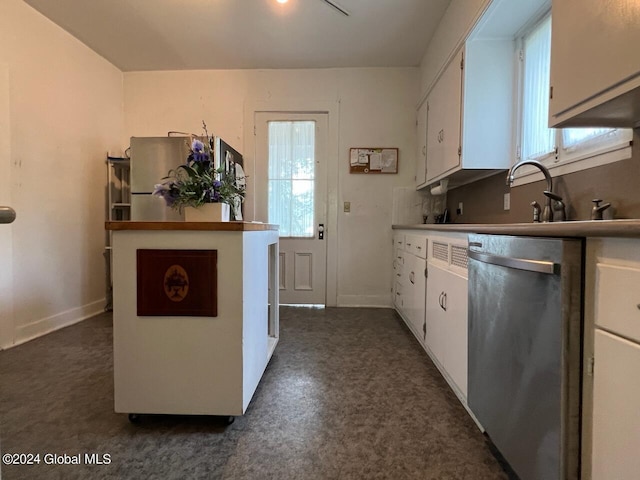 601/603 Baldwin Rd, Ticonderoga, NY 12883 - kitchen with stainless steel dishwasher, white cabinetry, baseboards, and a sink
