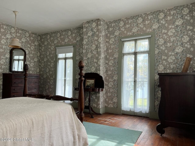601/603 Baldwin Rd, Ticonderoga, NY 12883 - bedroom featuring wood-type flooring and wallpapered walls