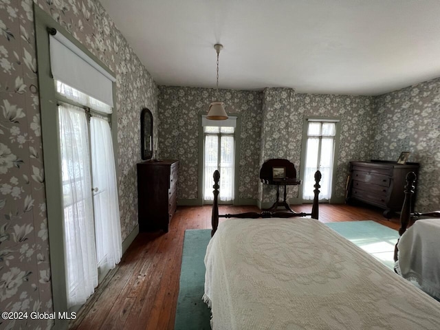 601/603 Baldwin Rd, Ticonderoga, NY 12883 - bedroom featuring wood-type flooring, wallpapered walls, and baseboards