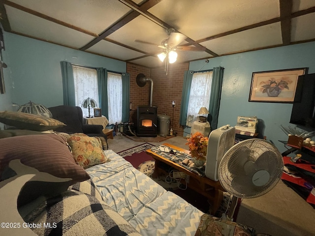96 Athol Rd, Thurman, NY 12810 - living area featuring a wood stove, carpet flooring, plenty of natural light, a ceiling fan, and coffered ceiling