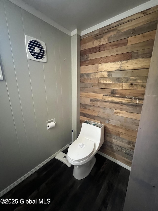 2299 Coach Rd, Argyle, NY 12809 - bathroom with wood walls, wood finished floors, baseboards, crown molding, and toilet