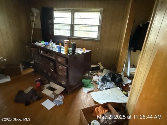 misc room with wooden walls and wood finished floors