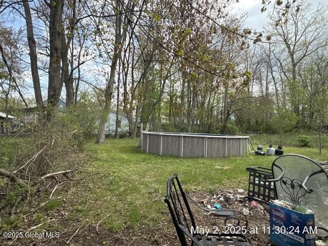 view of grassy yard featuring an outdoor pool