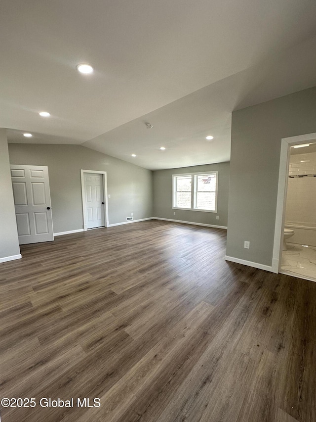 unfurnished room with dark wood finished floors, vaulted ceiling, baseboards, and recessed lighting