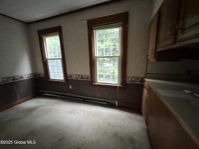92 N Pearl St, Schaghticoke, NY 12118 - unfurnished room with a baseboard radiator, plenty of natural light, wainscoting, and concrete floors