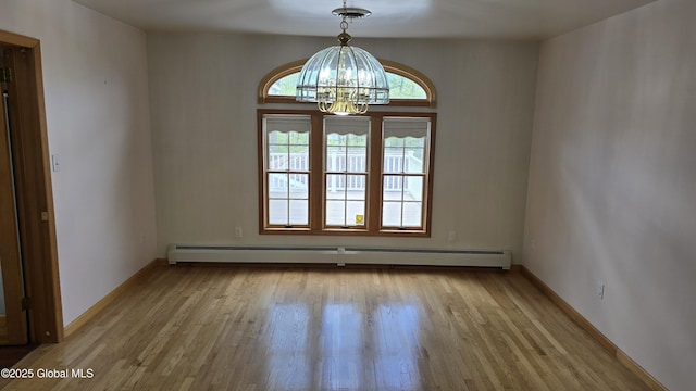 505 Elm Ave, Bethlehem, NY 12158 - empty room featuring baseboard heating, a chandelier, light wood finished floors, and baseboards