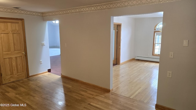 505 Elm Ave, Bethlehem, NY 12158 - empty room with a baseboard radiator, light wood-style floors, and baseboards