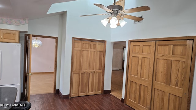 505 Elm Ave, Bethlehem, NY 12158 - unfurnished bedroom featuring freestanding refrigerator, dark wood-style flooring, multiple closets, baseboard heating, and a high ceiling
