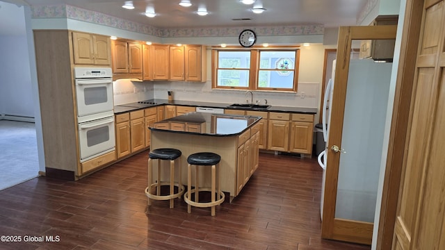 505 Elm Ave, Bethlehem, NY 12158 - kitchen with double oven, a sink, dark countertops, a baseboard radiator, and light brown cabinetry