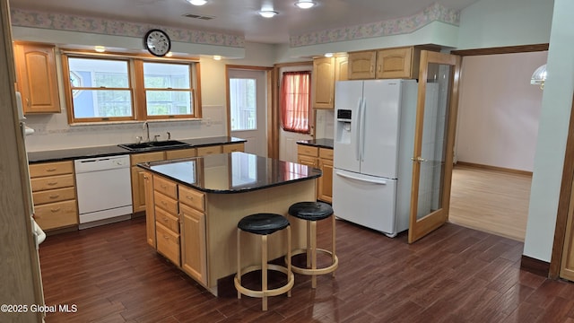 505 Elm Ave, Bethlehem, NY 12158 - kitchen featuring white appliances, a sink, dark countertops, dark wood-type flooring, and a center island