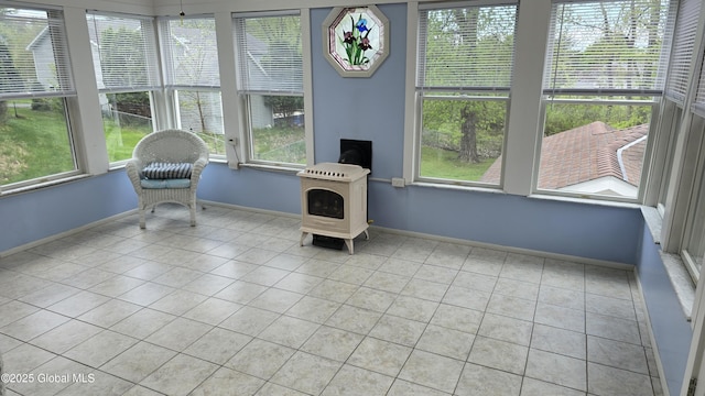 505 Elm Ave, Bethlehem, NY 12158 - sunroom with healthy amount of natural light, tile patterned flooring, and a wood stove