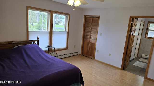 505 Elm Ave, Bethlehem, NY 12158 - bedroom featuring a baseboard radiator, multiple windows, and light wood-style flooring