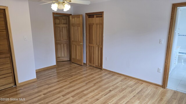 505 Elm Ave, Bethlehem, NY 12158 - unfurnished bedroom with light wood-type flooring, baseboards, ceiling fan, and a closet