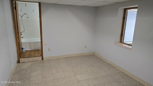 505 Elm Ave, Bethlehem, NY 12158 - unfurnished room with light tile patterned floors, a paneled ceiling, and baseboards
