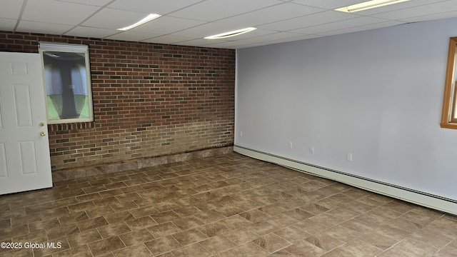 505 Elm Ave, Bethlehem, NY 12158 - spare room with a baseboard heating unit, a paneled ceiling, brick wall, and baseboards