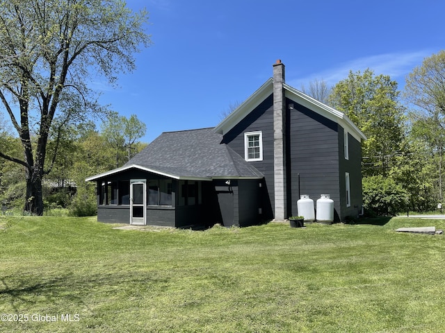 1054 Vly Smt, Cambridge, NY 12834 - rear view of property with a sunroom, roof with shingles, a chimney, and a lawn
