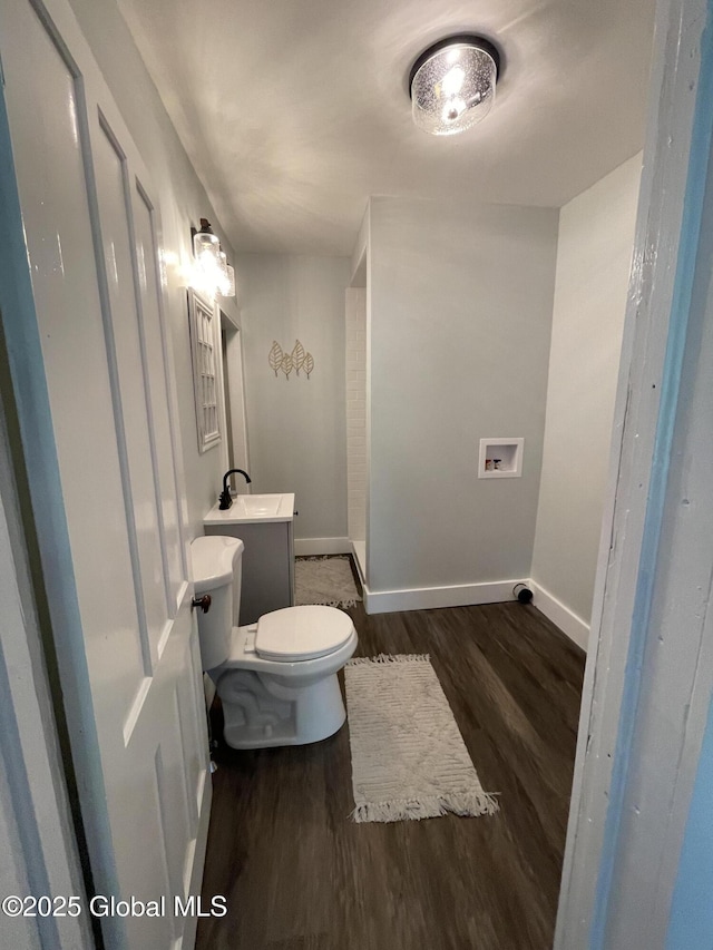 1054 Vly Smt, Cambridge, NY 12834 - half bathroom featuring wood finished floors, toilet, baseboards, and vanity