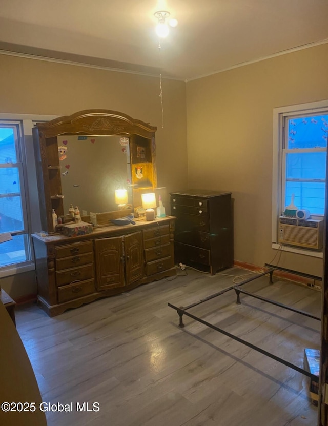 bedroom featuring crown molding and light wood-style floors