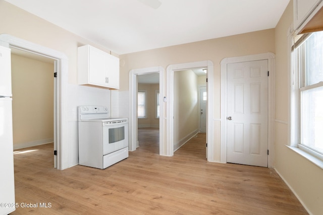 kitchen featuring electric range, light wood-style flooring, and healthy amount of natural light