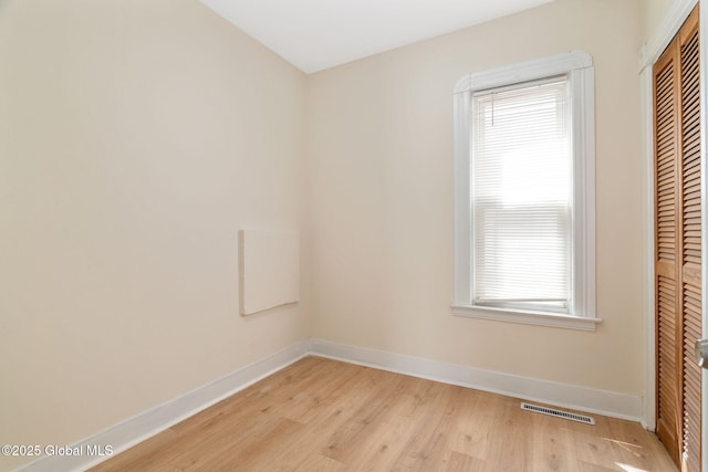 empty room with light wood-style floors and baseboards