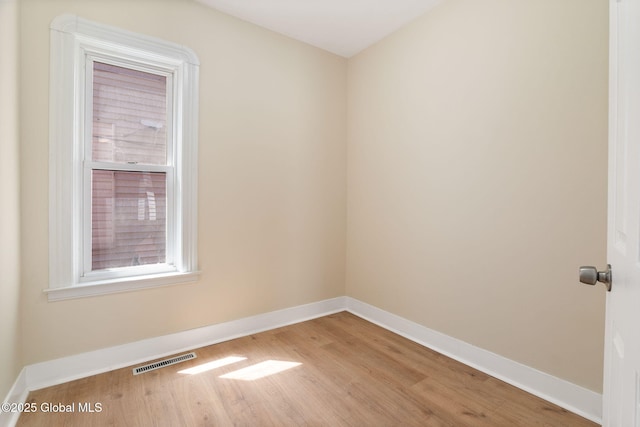 spare room with light wood-style flooring and baseboards