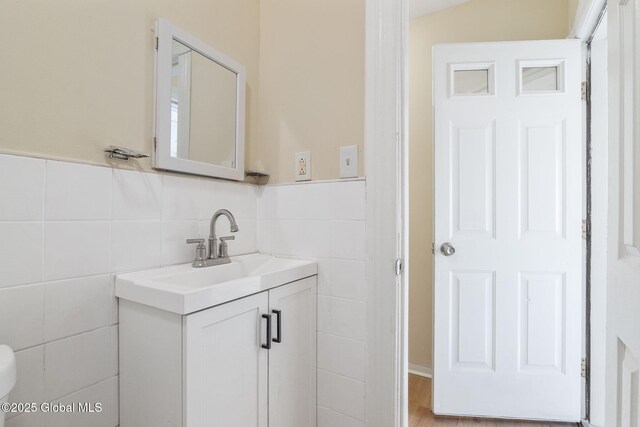 bathroom featuring tile walls and vanity