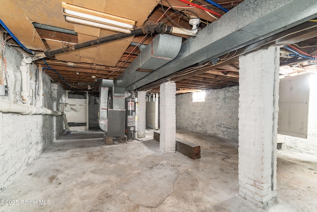 basement featuring water heater and heating unit