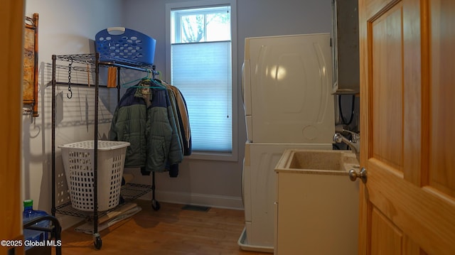 138 Church St, Saratoga Springs, Inside, NY 12866 - bathroom featuring estacked washer and dryer, wood finished floors, and baseboards