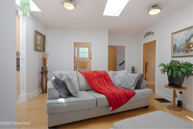 138 Church St, Saratoga Springs, Inside, NY 12866 - living room featuring a skylight, light wood-style flooring, and baseboards