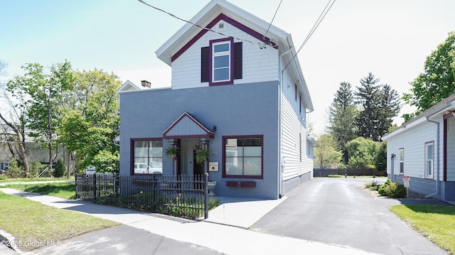 138 Church St, Saratoga Springs, Inside, NY 12866 - view of front of property featuring a fenced front yard and brick siding