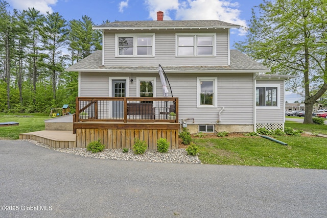 109 Wood Rd, Ballston Spa, NY 12020 - back of property with a wooden deck, a chimney, roof with shingles, and a yard