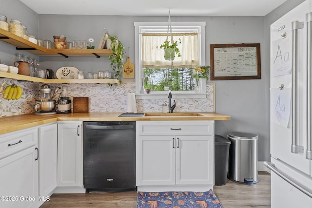 109 Wood Rd, Ballston Spa, NY 12020 - kitchen with black dishwasher, a sink, freestanding refrigerator, and light wood finished floors