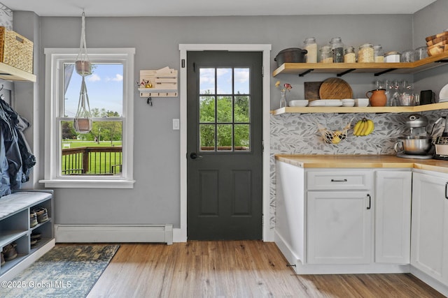 109 Wood Rd, Ballston Spa, NY 12020 - doorway to outside featuring a baseboard heating unit and light wood-style floors