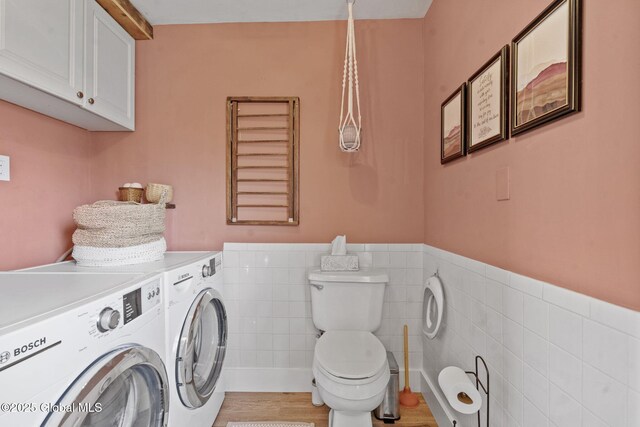 109 Wood Rd, Ballston Spa, NY 12020 - washroom with washing machine and clothes dryer, tile walls, wainscoting, and wood finished floors