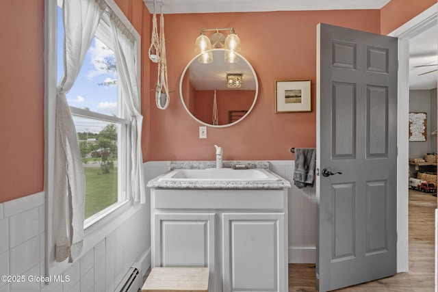 109 Wood Rd, Ballston Spa, NY 12020 - bathroom with tile walls, a wainscoted wall, vanity, and wood finished floors