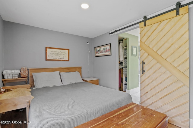 109 Wood Rd, Ballston Spa, NY 12020 - bedroom featuring a barn door and baseboards