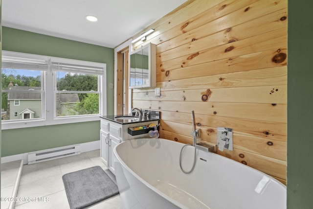 109 Wood Rd, Ballston Spa, NY 12020 - bathroom featuring baseboard heating, a freestanding bath, baseboards, vanity, and tile patterned floors
