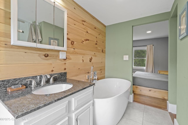 109 Wood Rd, Ballston Spa, NY 12020 - bathroom with a soaking tub, vanity, tile patterned flooring, baseboards, and recessed lighting