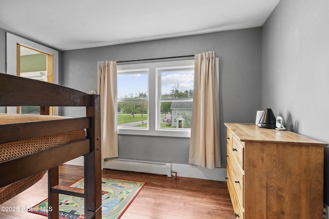 109 Wood Rd, Ballston Spa, NY 12020 - bedroom with a baseboard heating unit and wood finished floors