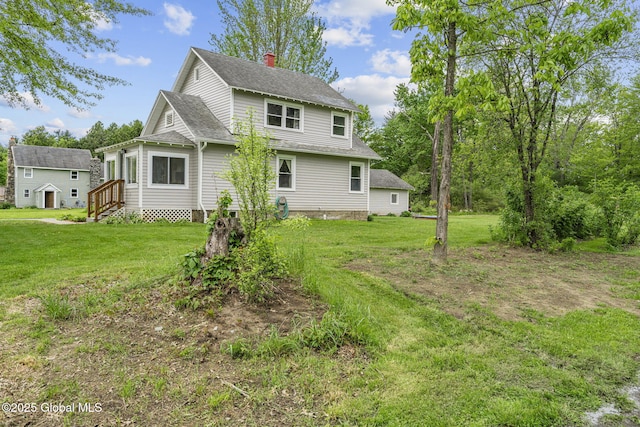 109 Wood Rd, Ballston Spa, NY 12020 - rear view of house featuring a chimney, entry steps, a shingled roof, and a yard