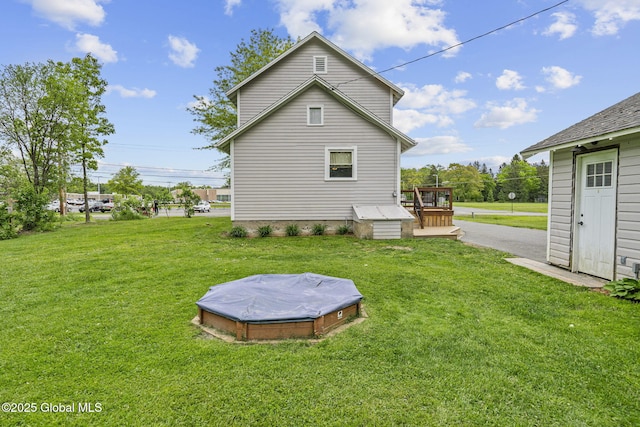 109 Wood Rd, Ballston Spa, NY 12020 - back of property featuring a wooden deck and a lawn