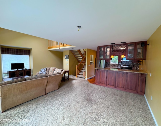 110 Juniper Hill Dr Unit 34, Bolton, NY 12814 - carpeted living room with stairway, baseboards, and bar