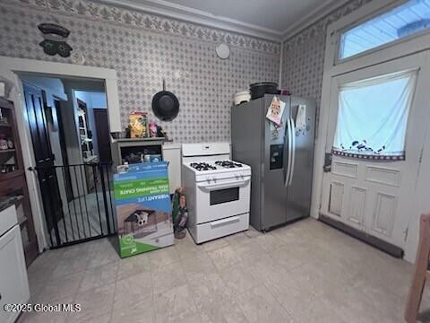 436 Lower Main St, Fort Edward, NY 12839 - kitchen with white range with gas stovetop, stainless steel refrigerator with ice dispenser, crown molding, and wallpapered walls