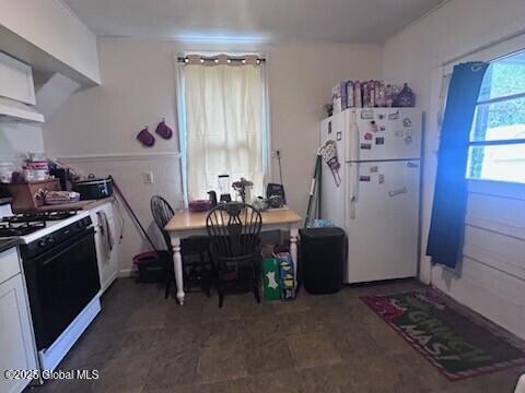 436 Lower Main St, Fort Edward, NY 12839 - kitchen featuring white appliances, white cabinetry, and under cabinet range hood