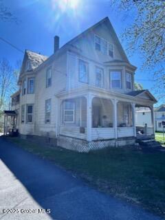 436 Lower Main St, Fort Edward, NY 12839 - view of front of house featuring a chimney and a porch