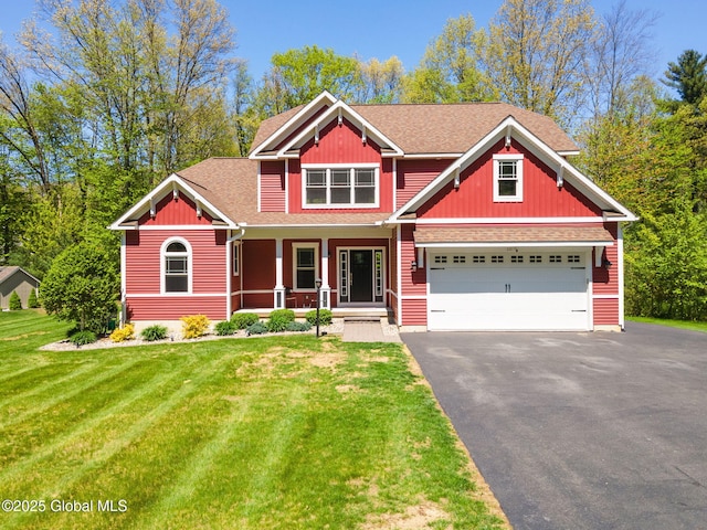 craftsman house featuring covered porch, asphalt driveway, roof with shingles, and a front yard