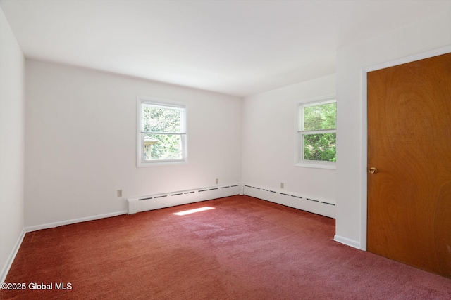 carpeted empty room with a baseboard radiator and baseboards