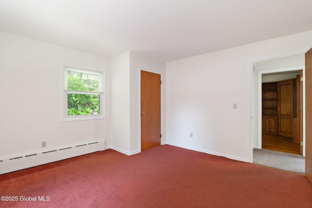 unfurnished room with carpet, a baseboard radiator, and baseboards