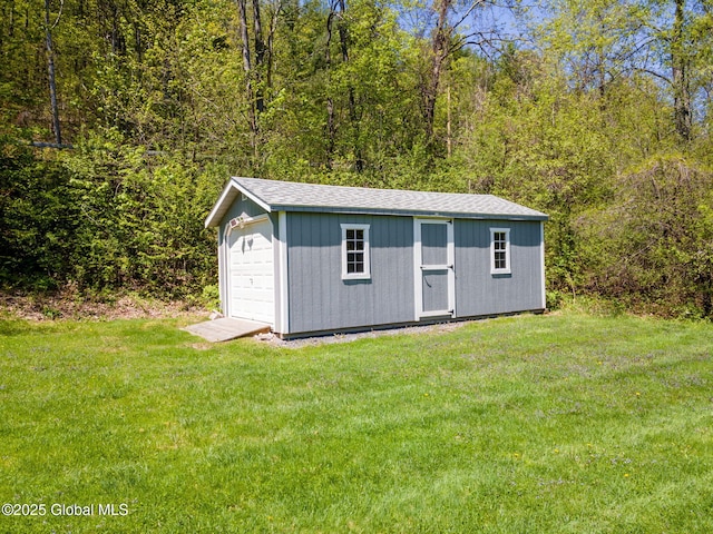 view of outbuilding featuring an outbuilding and a forest view